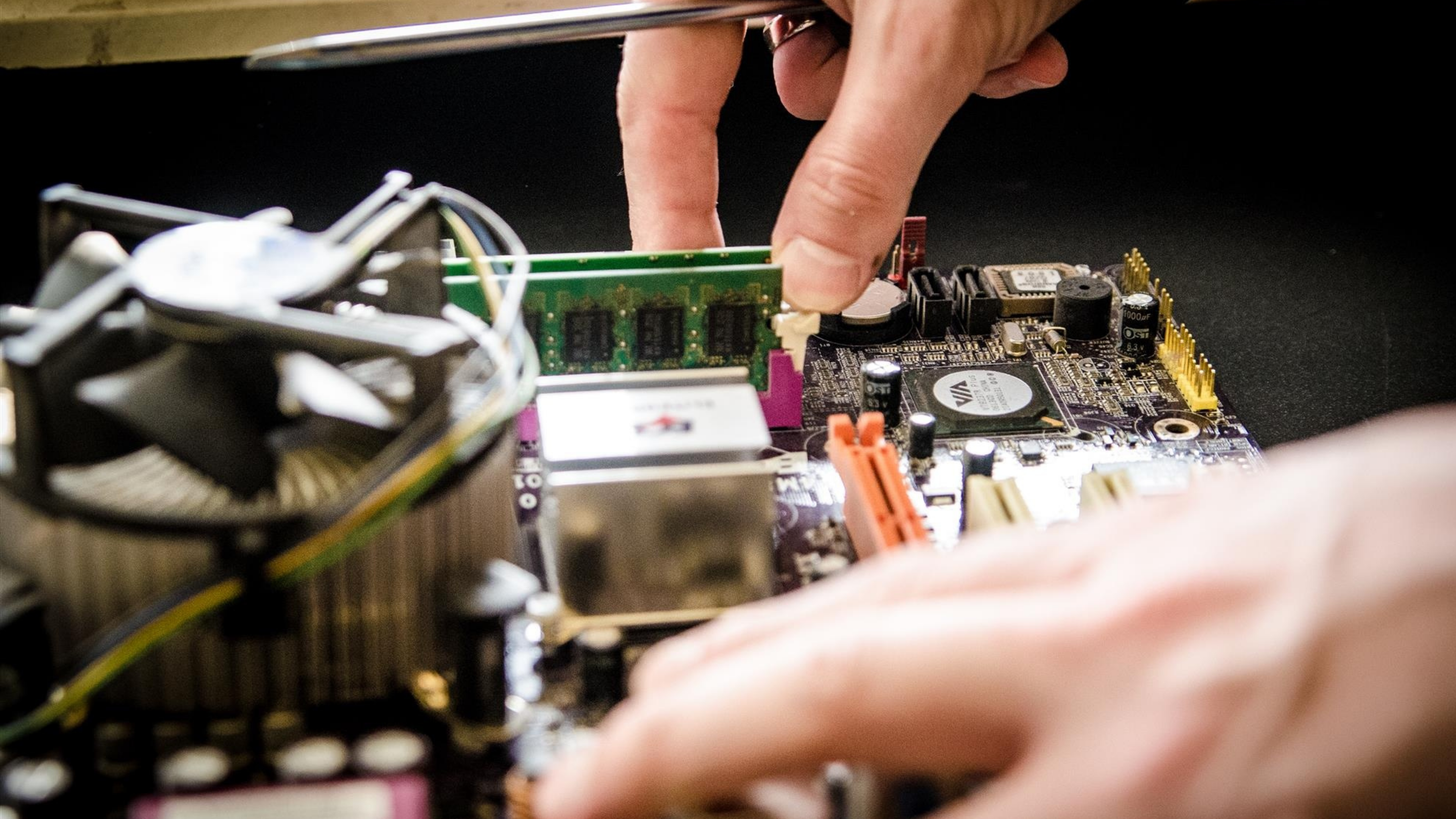 An up close image of a computer repair being performed.
